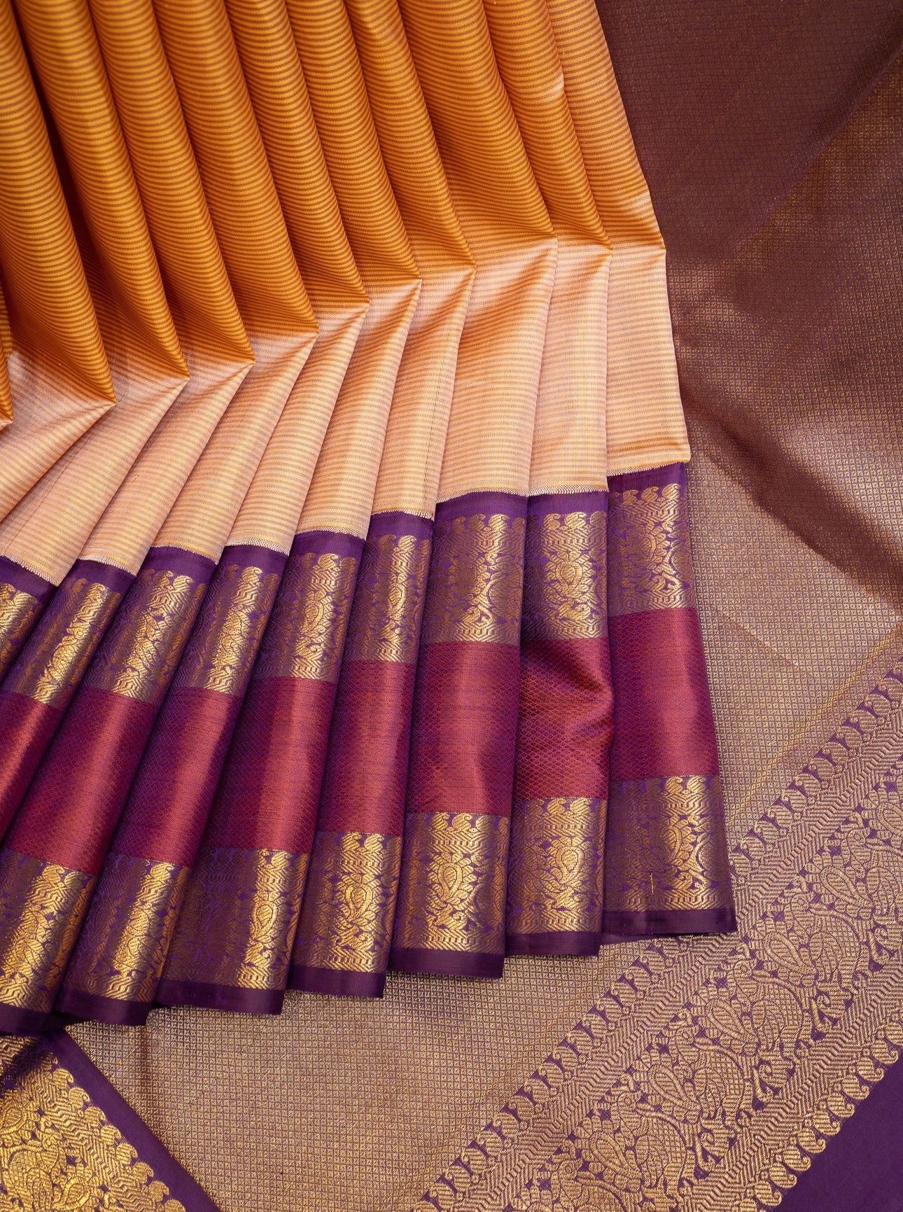 Orange arumbu manga buttas Vasundhara silk saree with contrast rettai pettu border of salngai, diamond, and kodi visiry designs, and intricate pallu