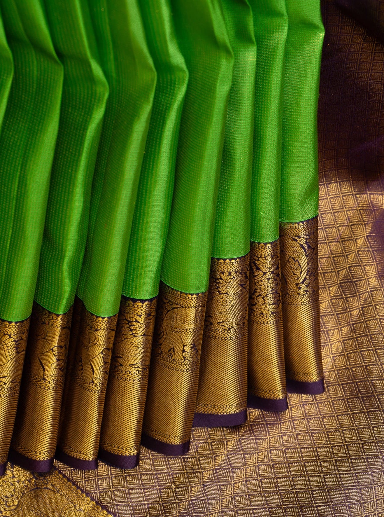 Green jacquard wedding silk saree, zari border of rekku, muthu, and manga designs, and intricate pallu