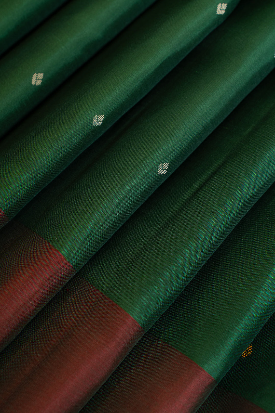 Green fabric with red border and white patterns