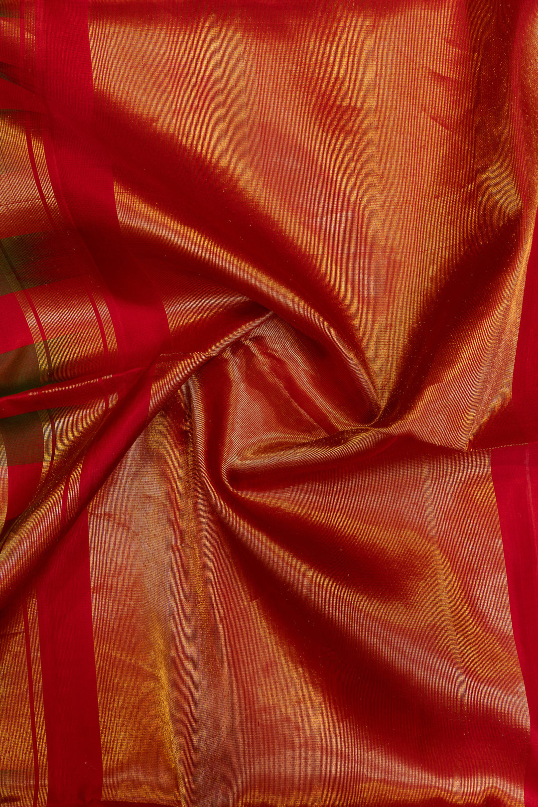 Close-up of red and orange fabric with a subtle pattern