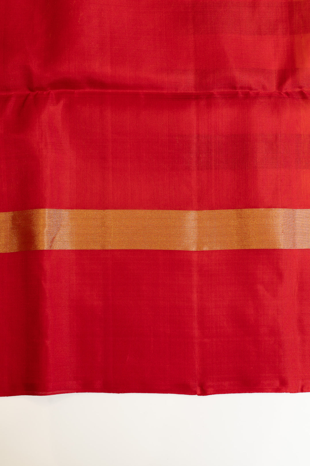 Red fabric with a subtle pattern on a white background