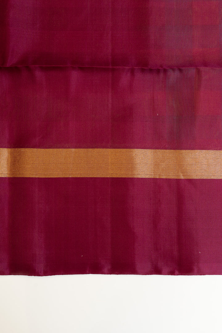 Close-up of maroon fabric with a subtle pattern on a white background