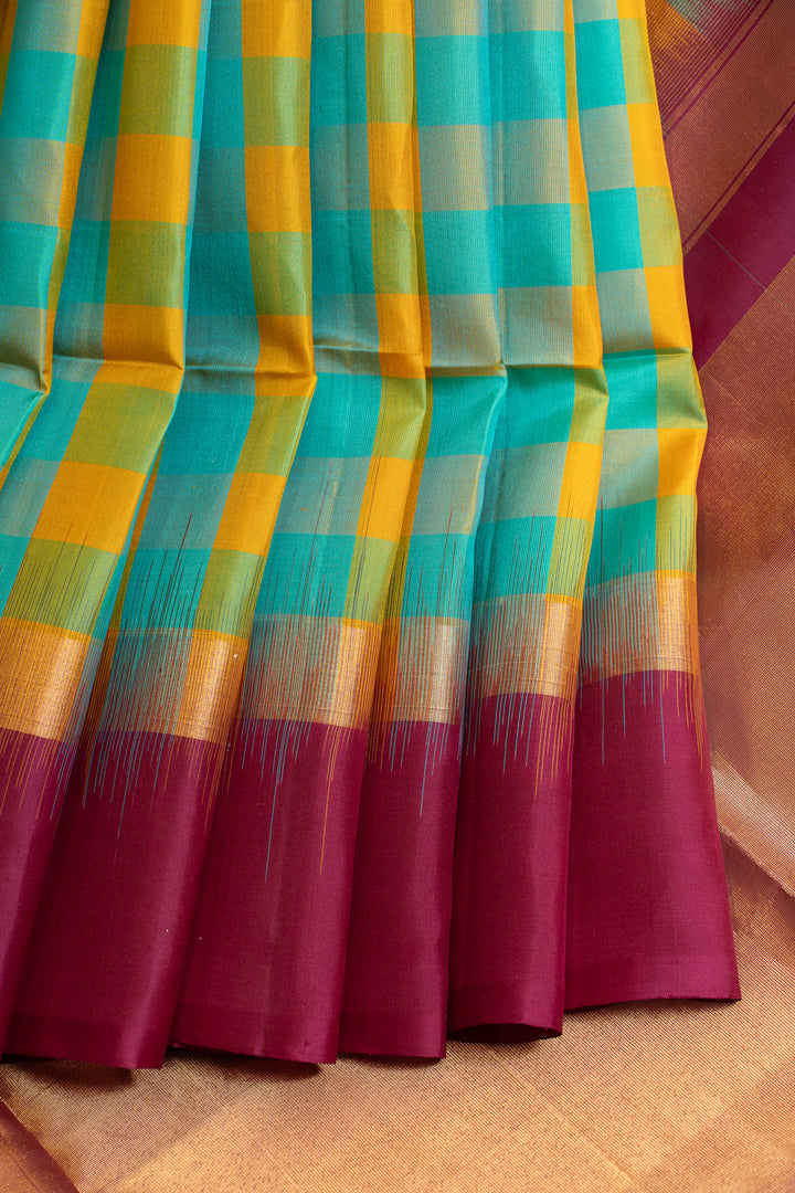 Colorful checkered fabric with a magenta border on a textured surface