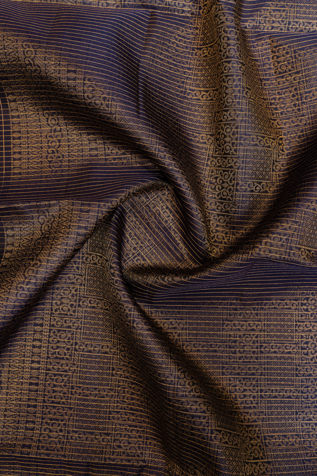 Textured fabric with a pattern of interwoven lines and shapes.