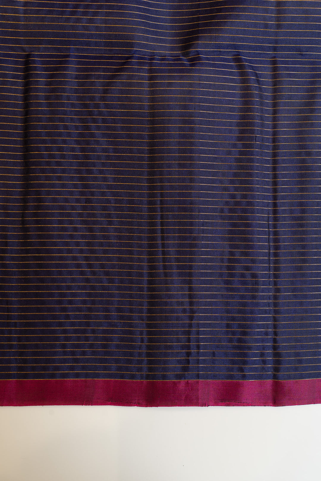 Navy fabric with thin red stripe on a white background
