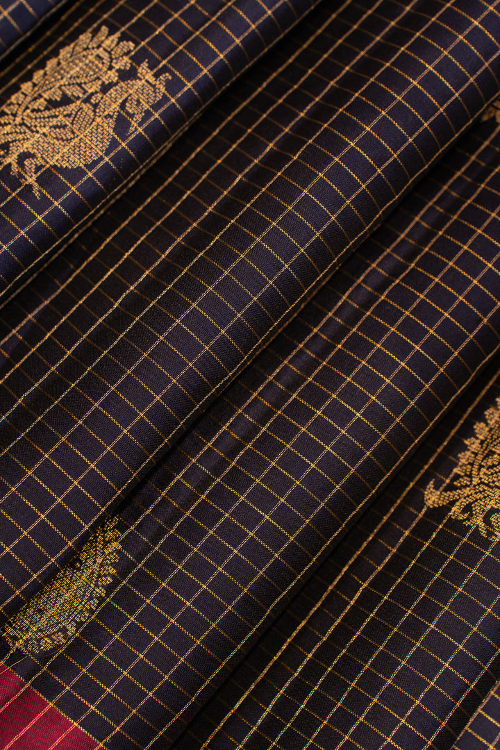 Navy blue fabric with gold checkered pattern and embroidered designs
