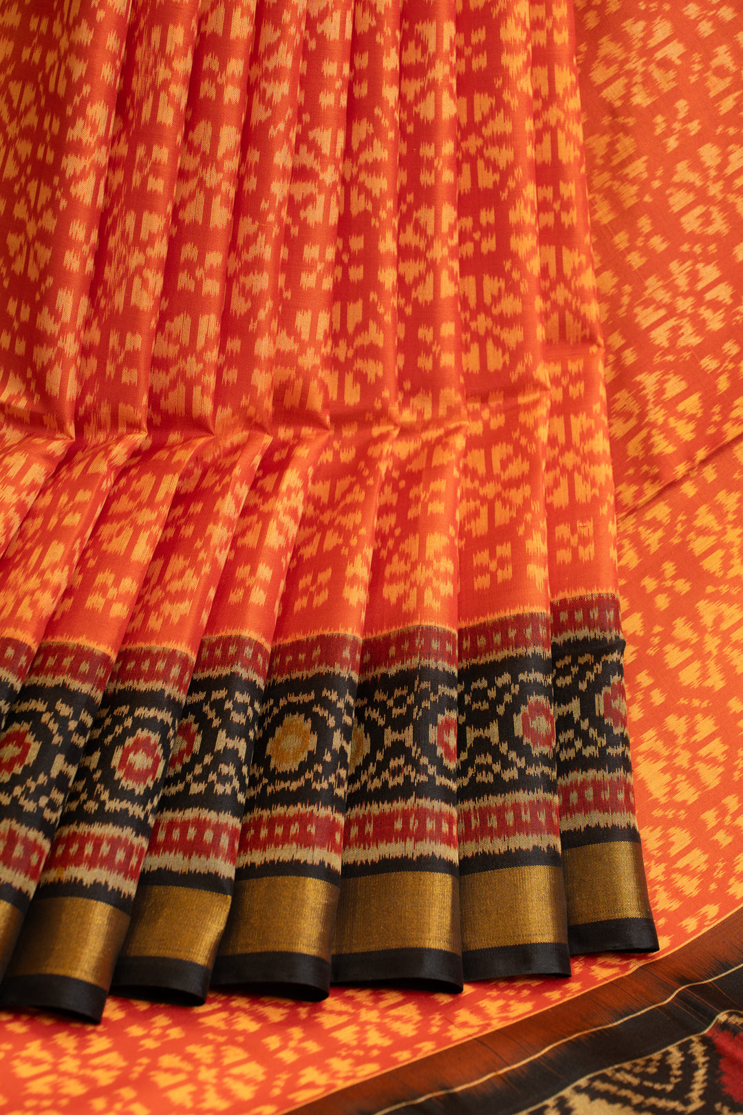 Rust orange and black pure patola ikat silk saree