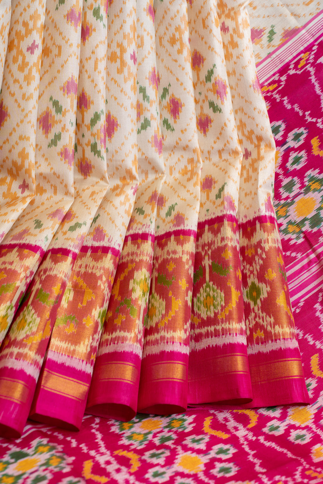 Off white and pink pure Patola ikat silk saree