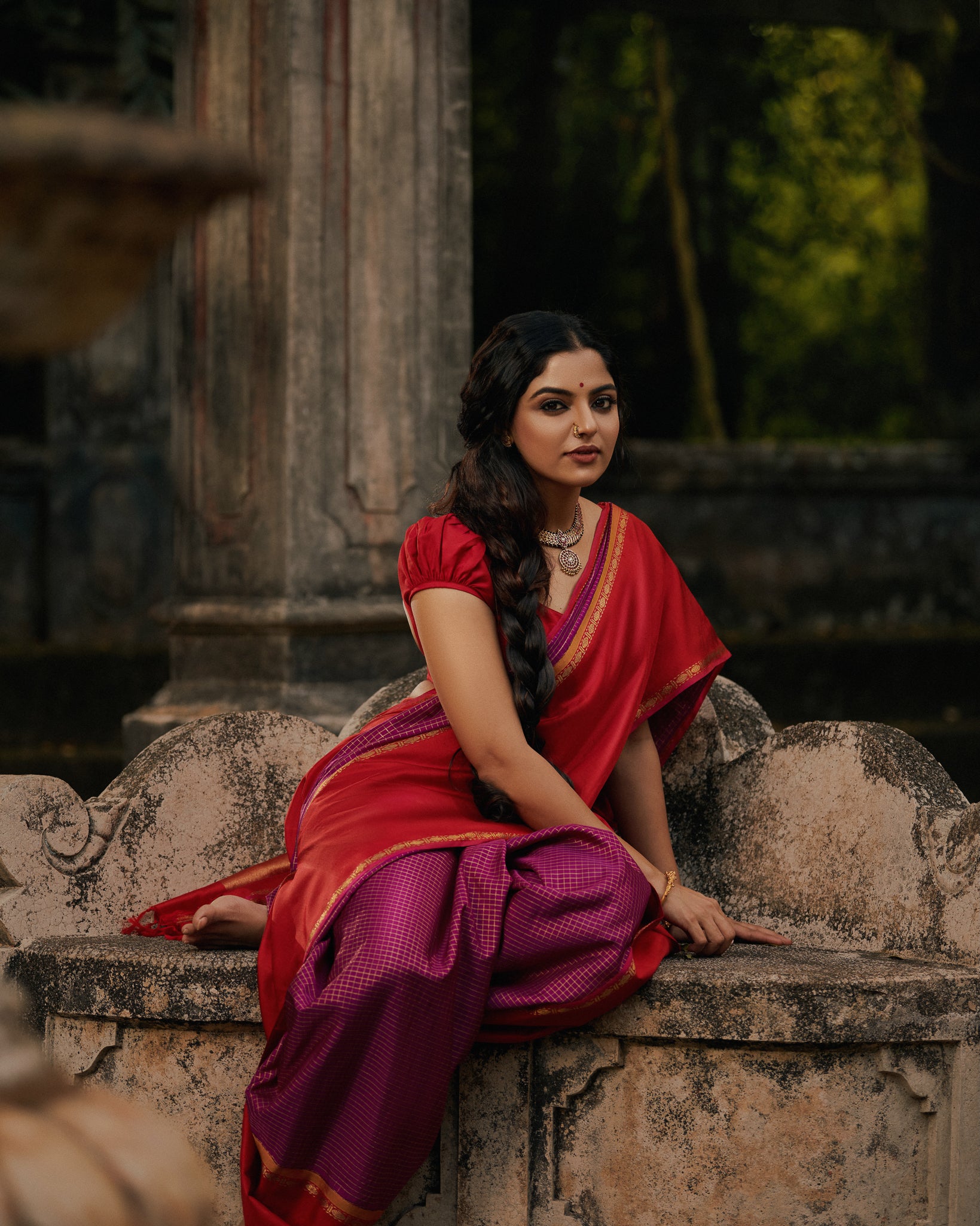 woman gracefully draped in a vibrant Kanchipuram silk saree, showcasing the rich texture and intricate designs perfect for traditional festivals like Navratri, Dussehra, and Diwali