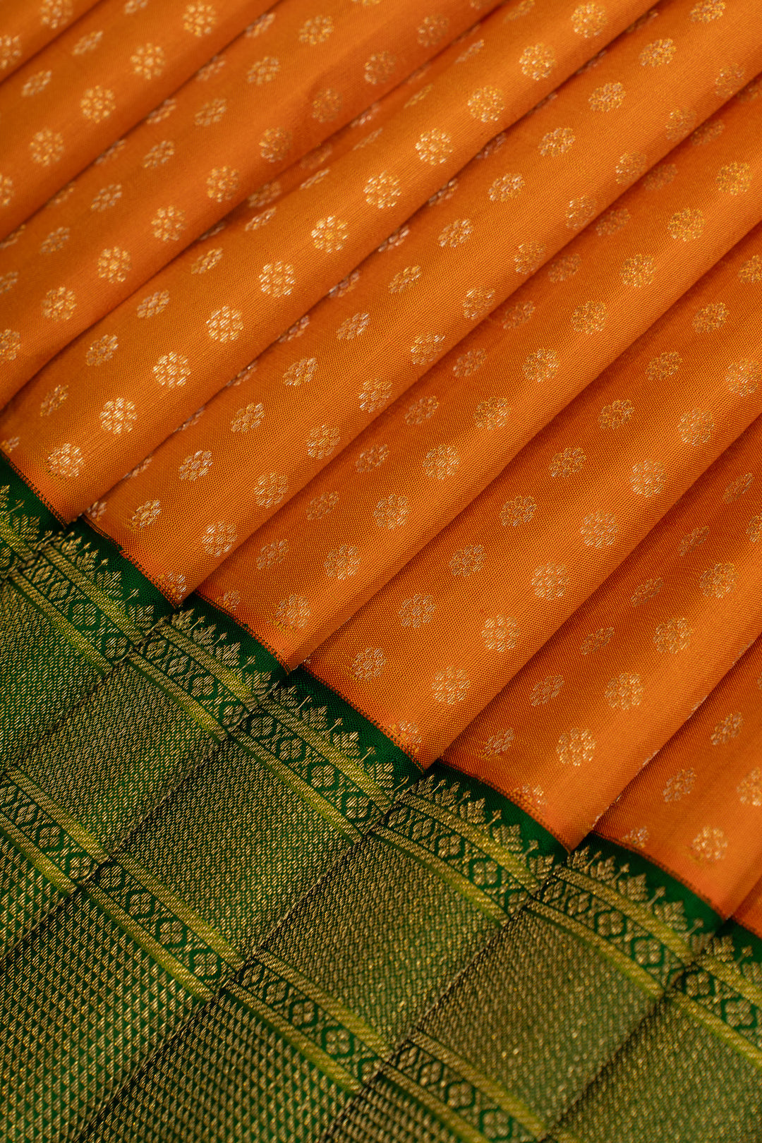 Orange and green lakshadeepam turning border pure Kanchipuram silk saree
