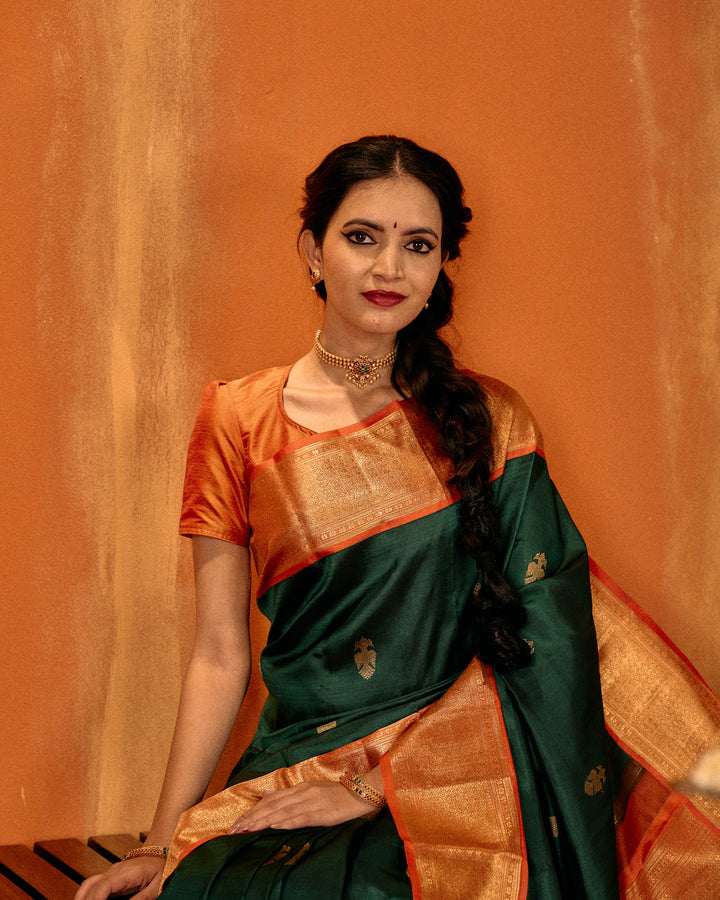 Bottle green and orange iruthalaipakshi pure Kanchipuram silk saree