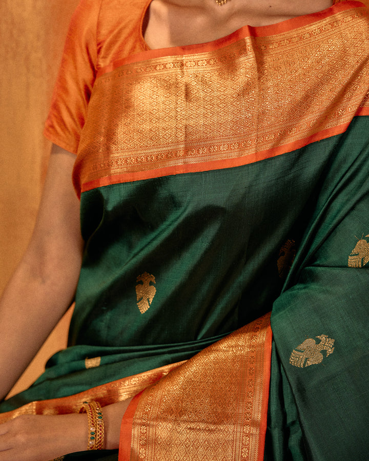 Bottle green and orange iruthalaipakshi pure Kanchipuram silk saree