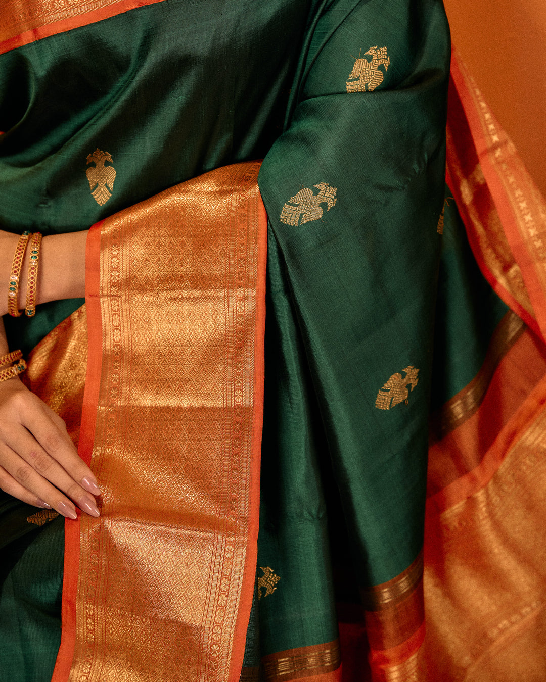 Bottle green and orange iruthalaipakshi pure Kanchipuram silk saree