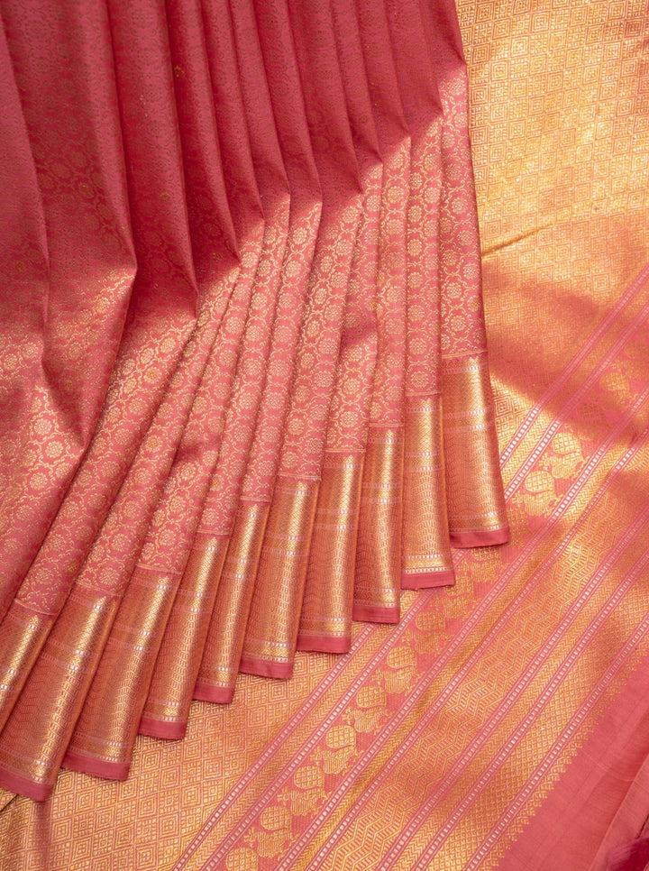 Exquisite traditional Kanchipuram silk saree, featuring intricate golden zari work on a richly woven silk fabric, showcasing timeless elegance and cultural heritage.