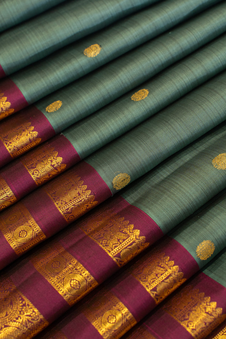 Greenish blue and magenta stripes border pure Kanchipuram silk saree