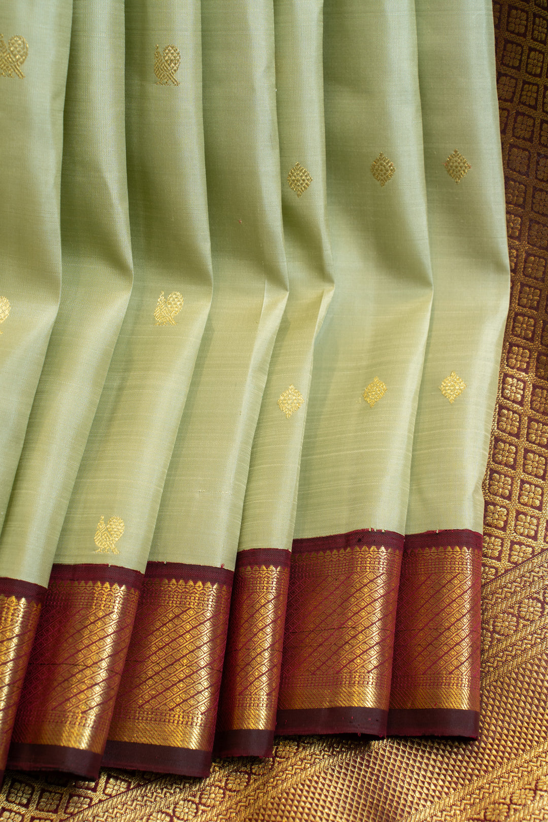 Tea green Kanchipuram silk saree with jamun border

