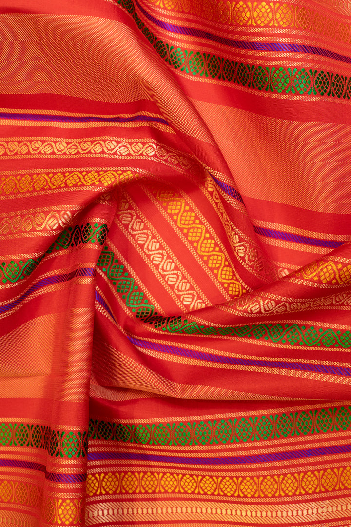 Detailed shot of the pallu design on a Peacock Blue and Red pure Kanchipuram silk saree.