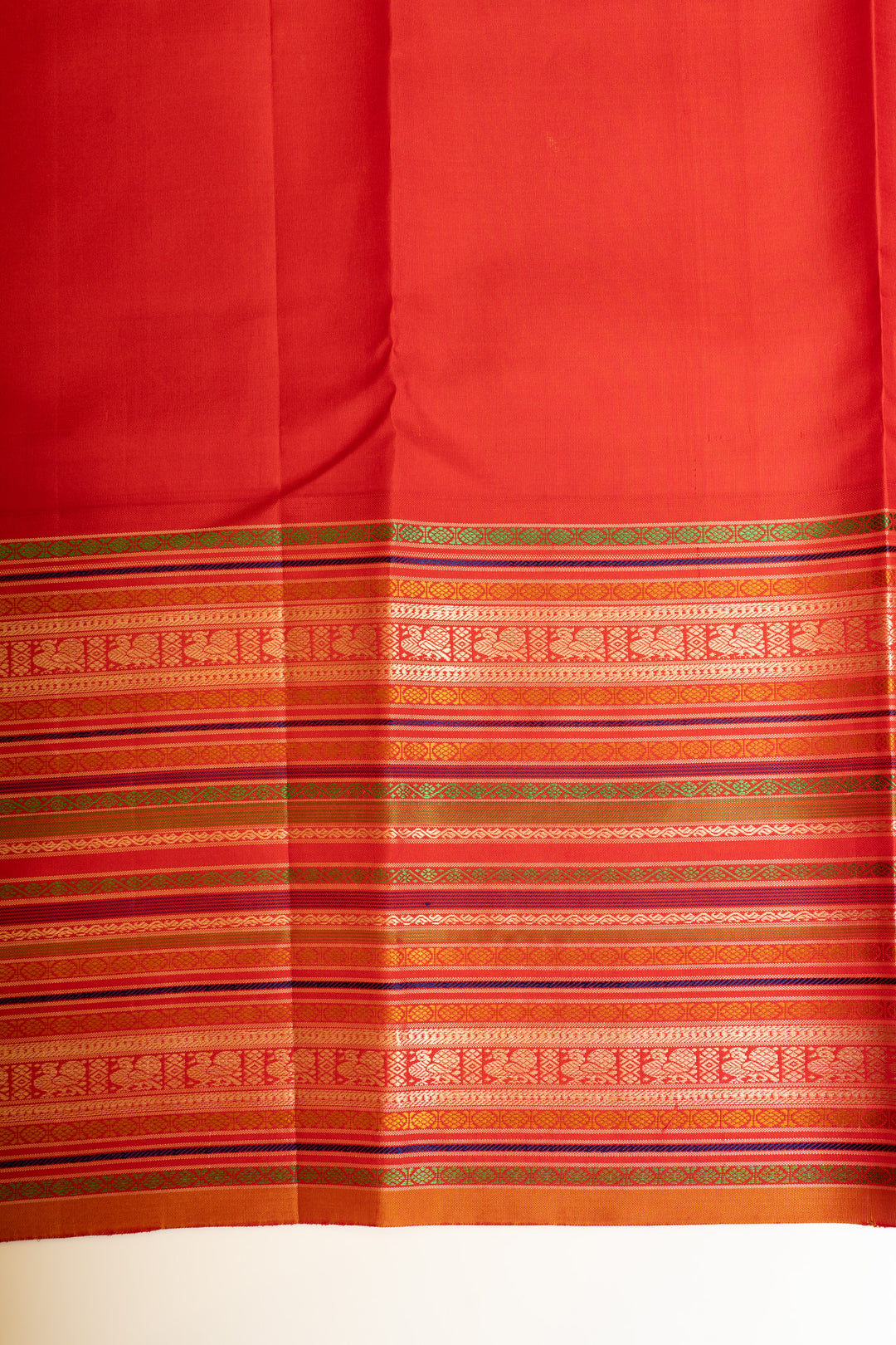 Matching blouse paired with the Peacock Blue and Red pure Kanchipuram silk saree.