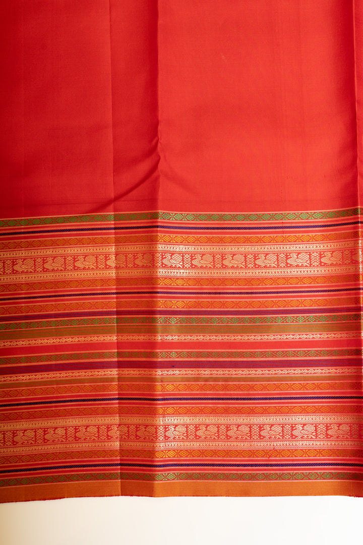 Matching blouse paired with the Peacock Blue and Red pure Kanchipuram silk saree.