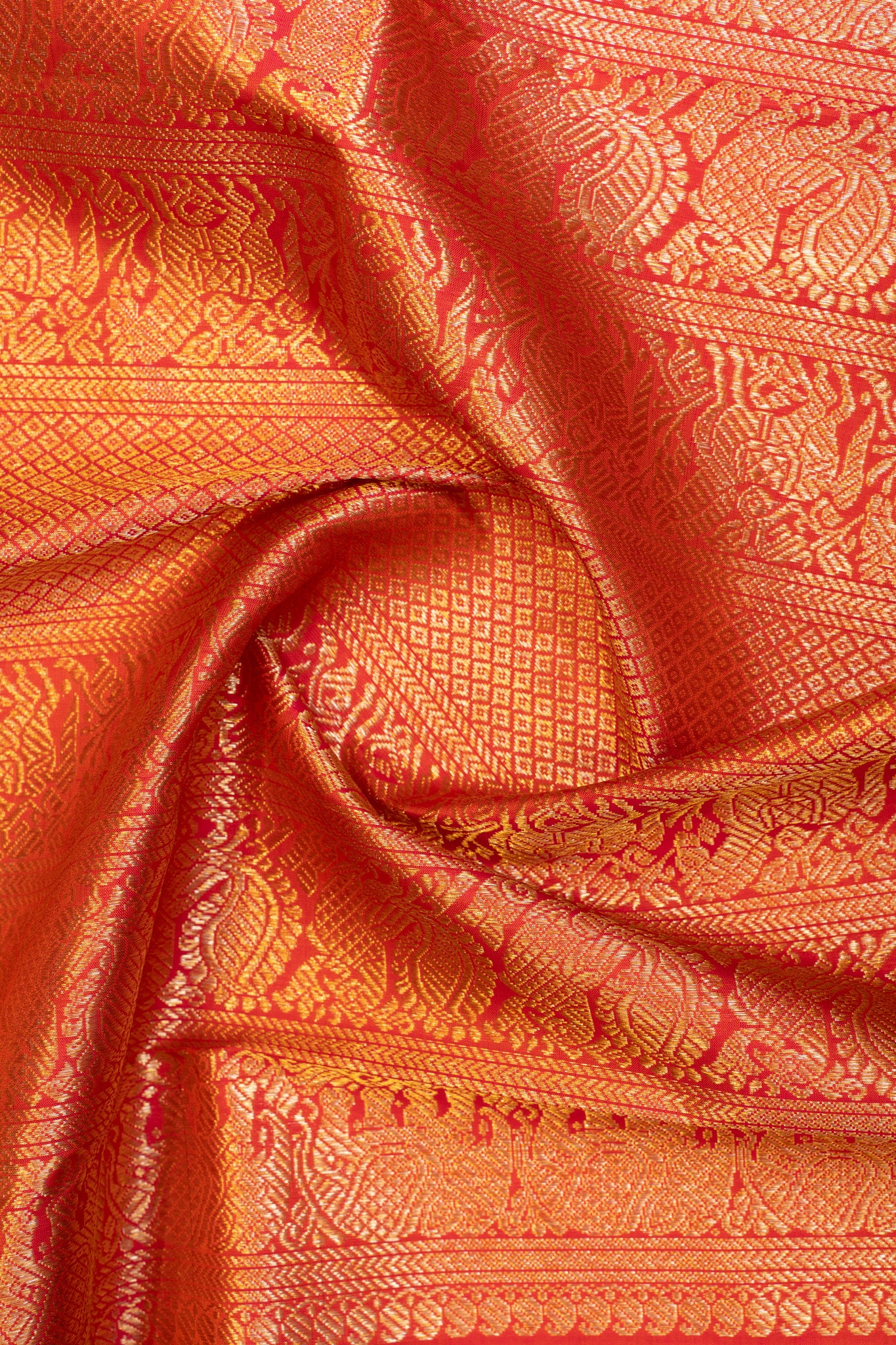 Detailed shot of the pallu of a black and peach Kanchipuram silk saree with ornate zari work