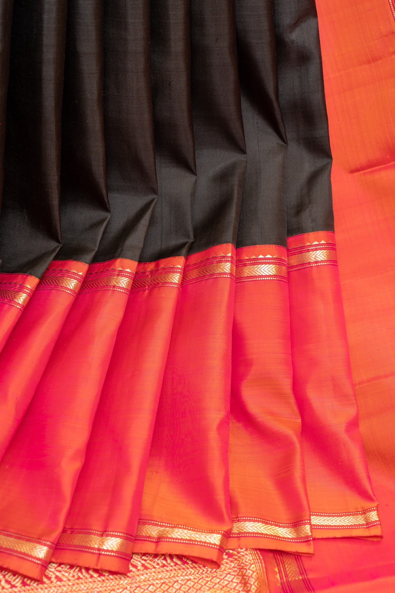 Full view of a black and peach pure Kanchipuram silk saree with intricate zari detailing, showcasing its elegance