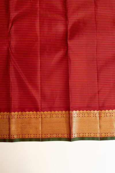 Elegant maroon blouse paired with an off white zari checks Kanjivaram silk saree, enhancing its timeless appeal