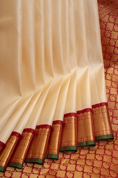 Full view of an off white zari checks and maroon traditional pure Kanjivaram silk saree, showcasing its classic elegance.