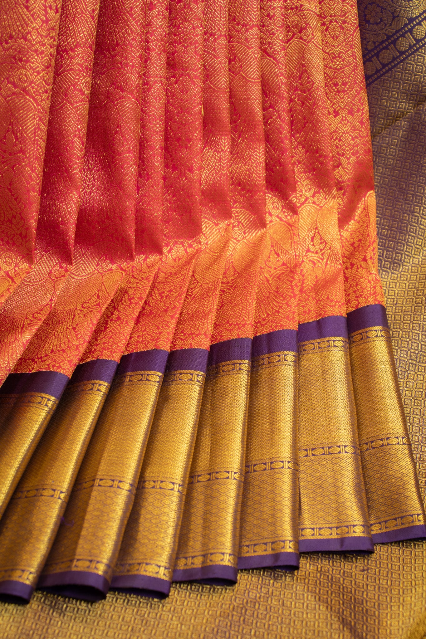 Full view of a crimson red Iruthalaipakshi brocade Kanjivaram silk saree showcasing its intricate design and rich texture