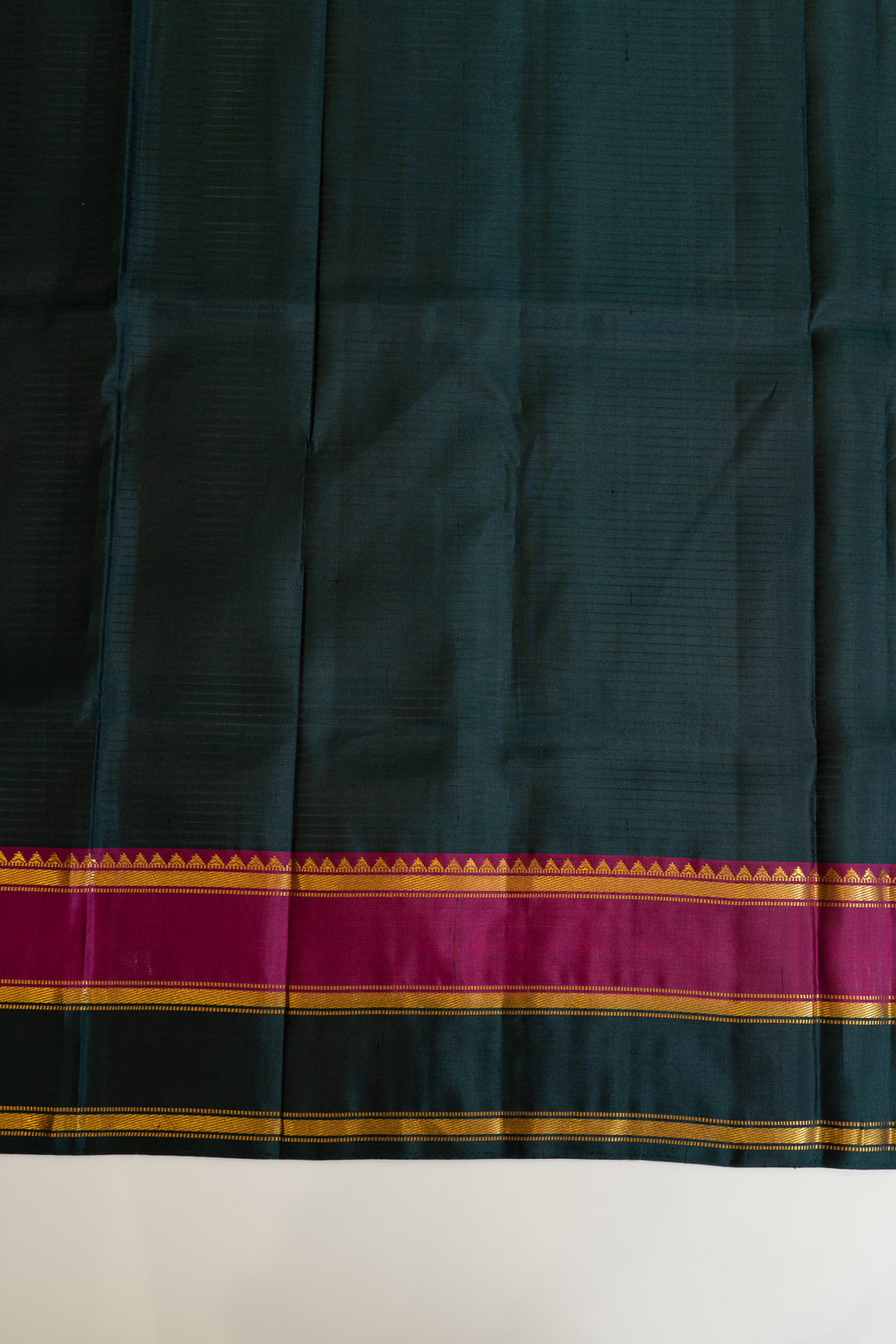 Dark green fabric with a colorful border on a white background