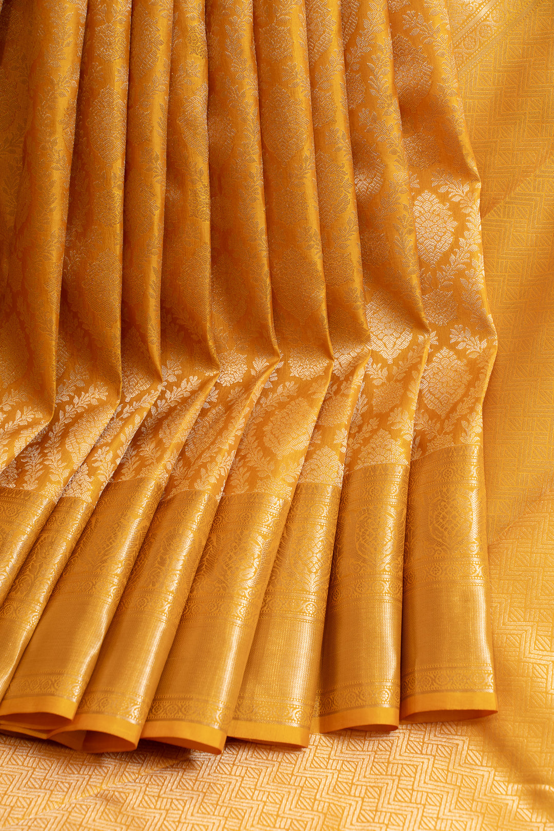 Close-up of a yellow fabric with intricate patterns