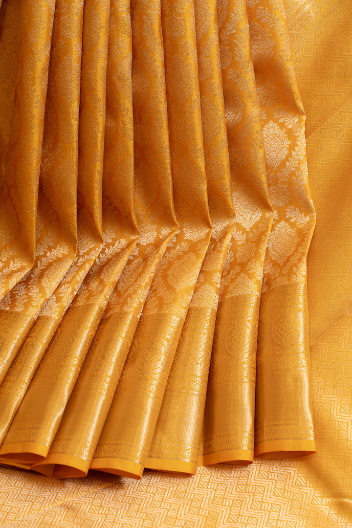 Close-up of a yellow fabric with intricate patterns