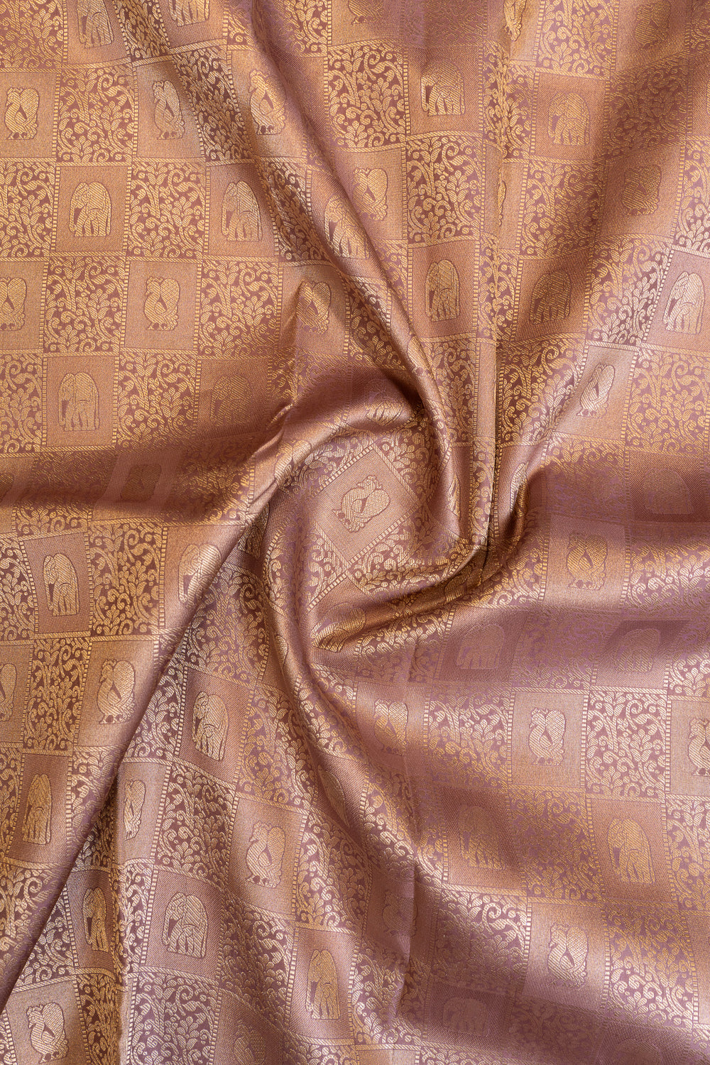 Close-up of patterned fabric with intricate designs on a brown background