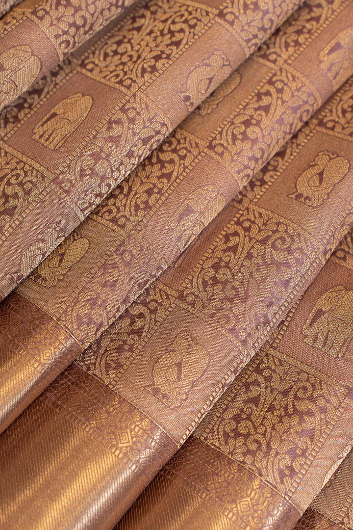 Close-up of brown fabric with intricate gold patterns
