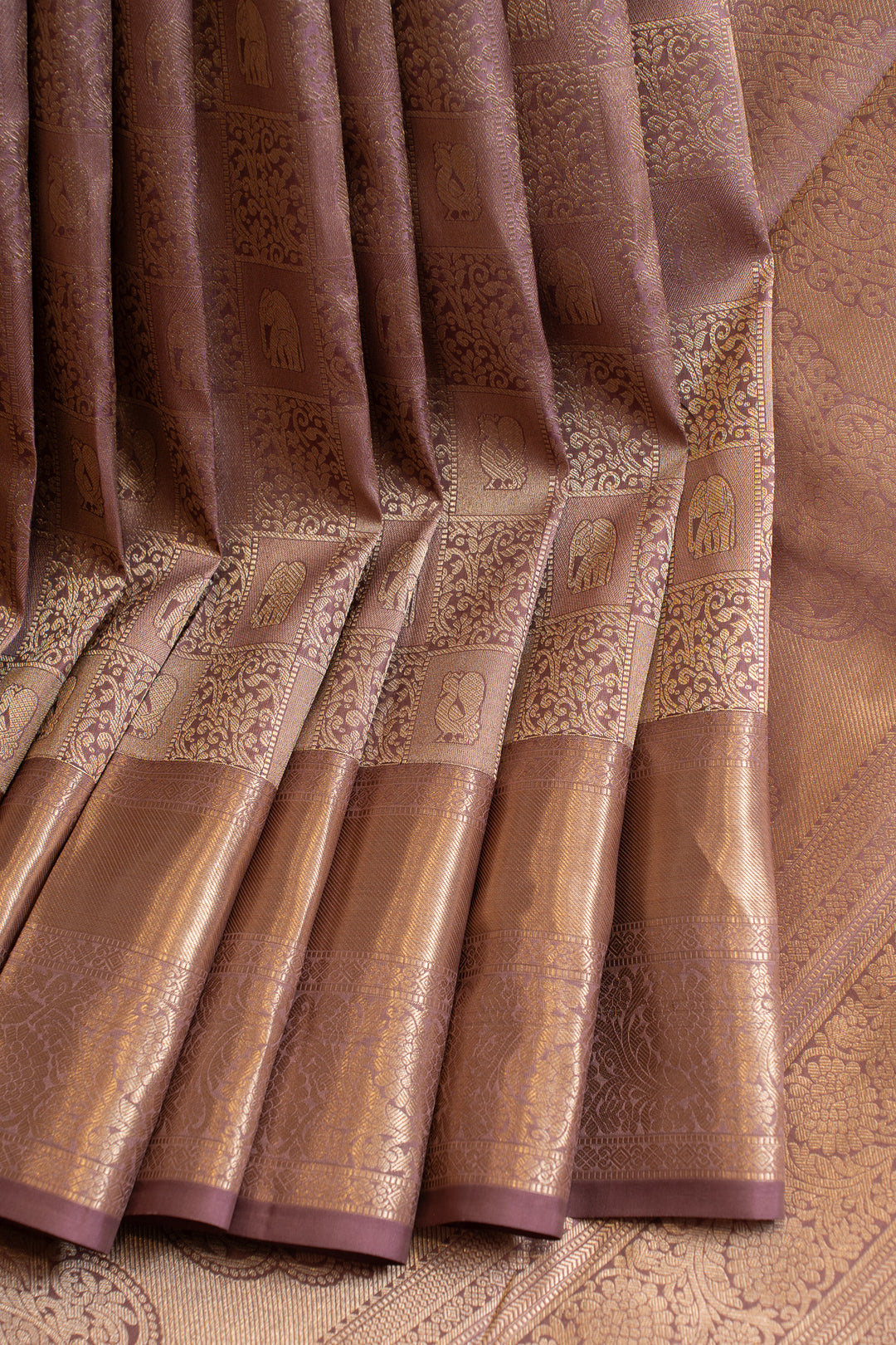 Close-up of a brown fabric with intricate patterns and embroidery.
