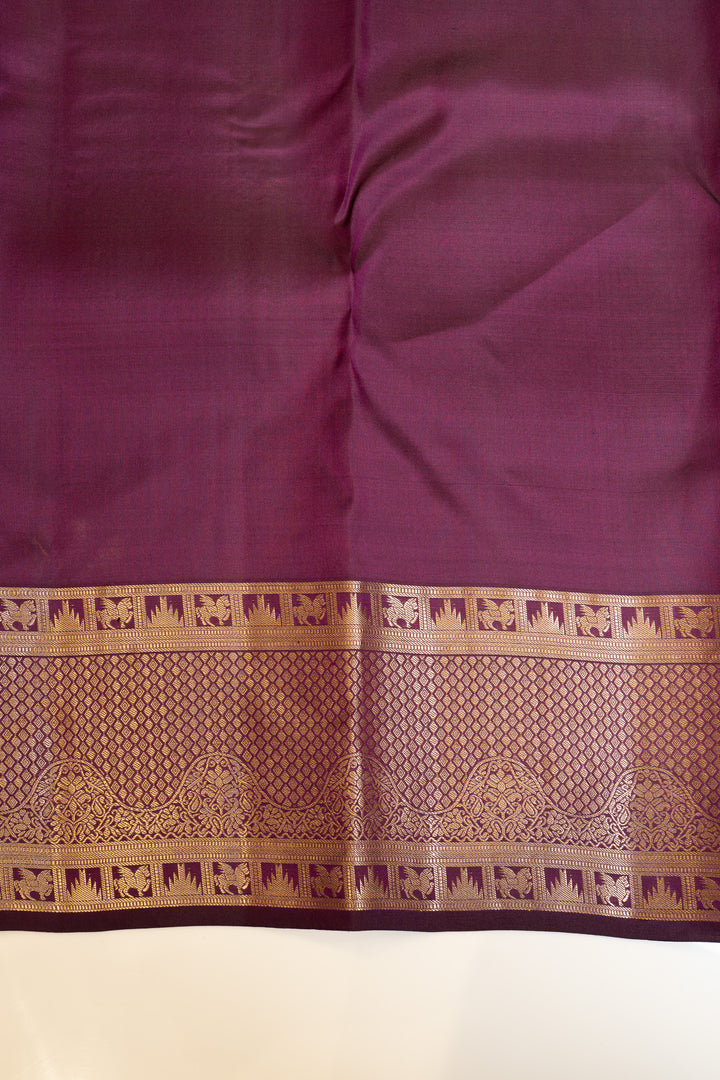 Purple fabric with a gold border featuring elephant patterns on a white background