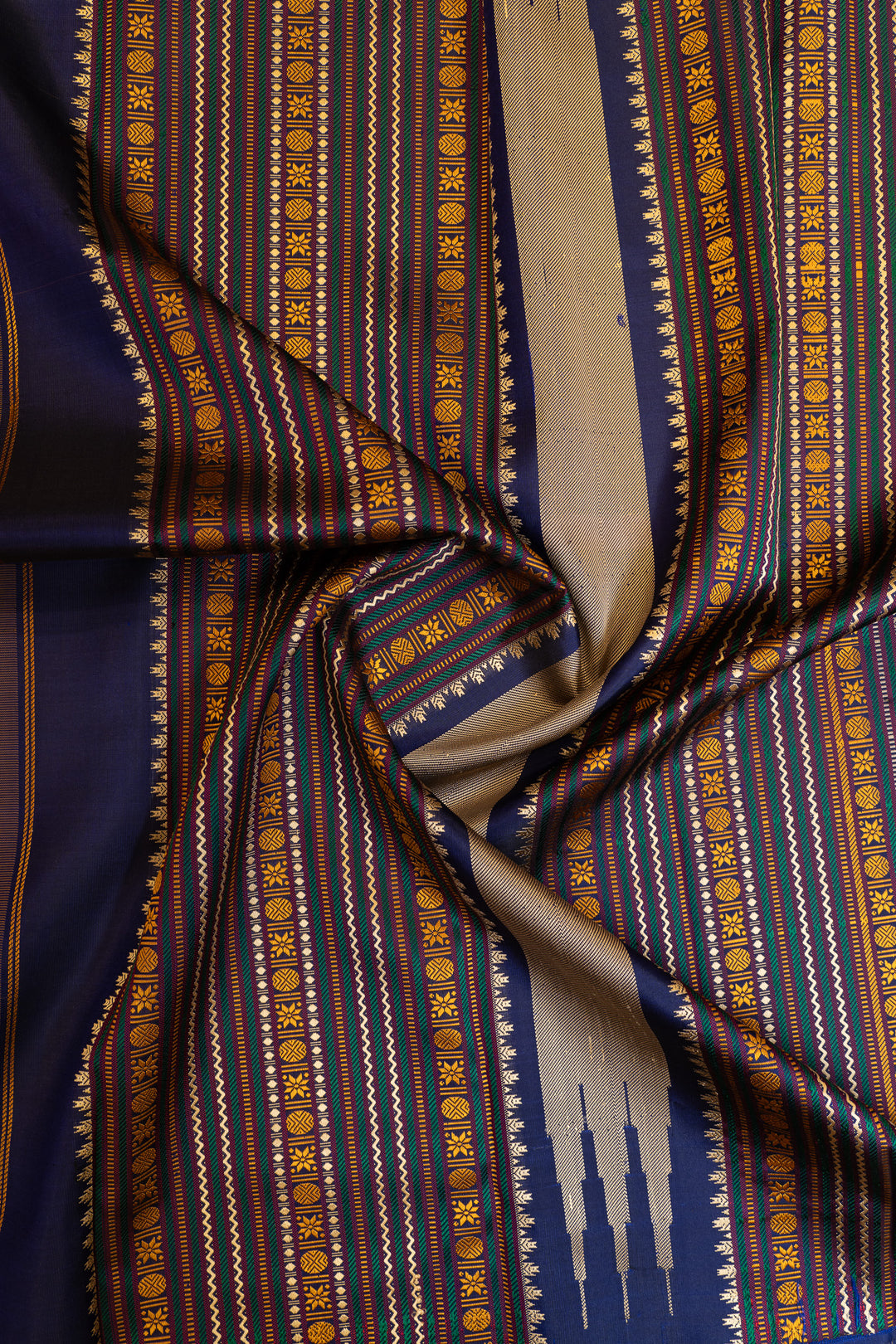 Close-up of patterned fabric with blue, gold, and beige colors.