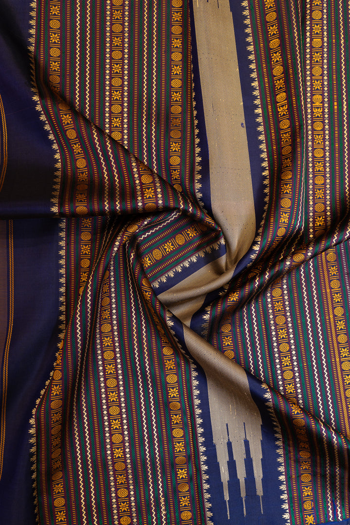 Close-up of patterned fabric with blue, gold, and beige colors.