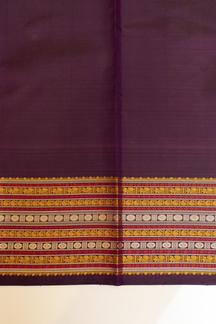 Purple fabric with a decorative yellow and red border