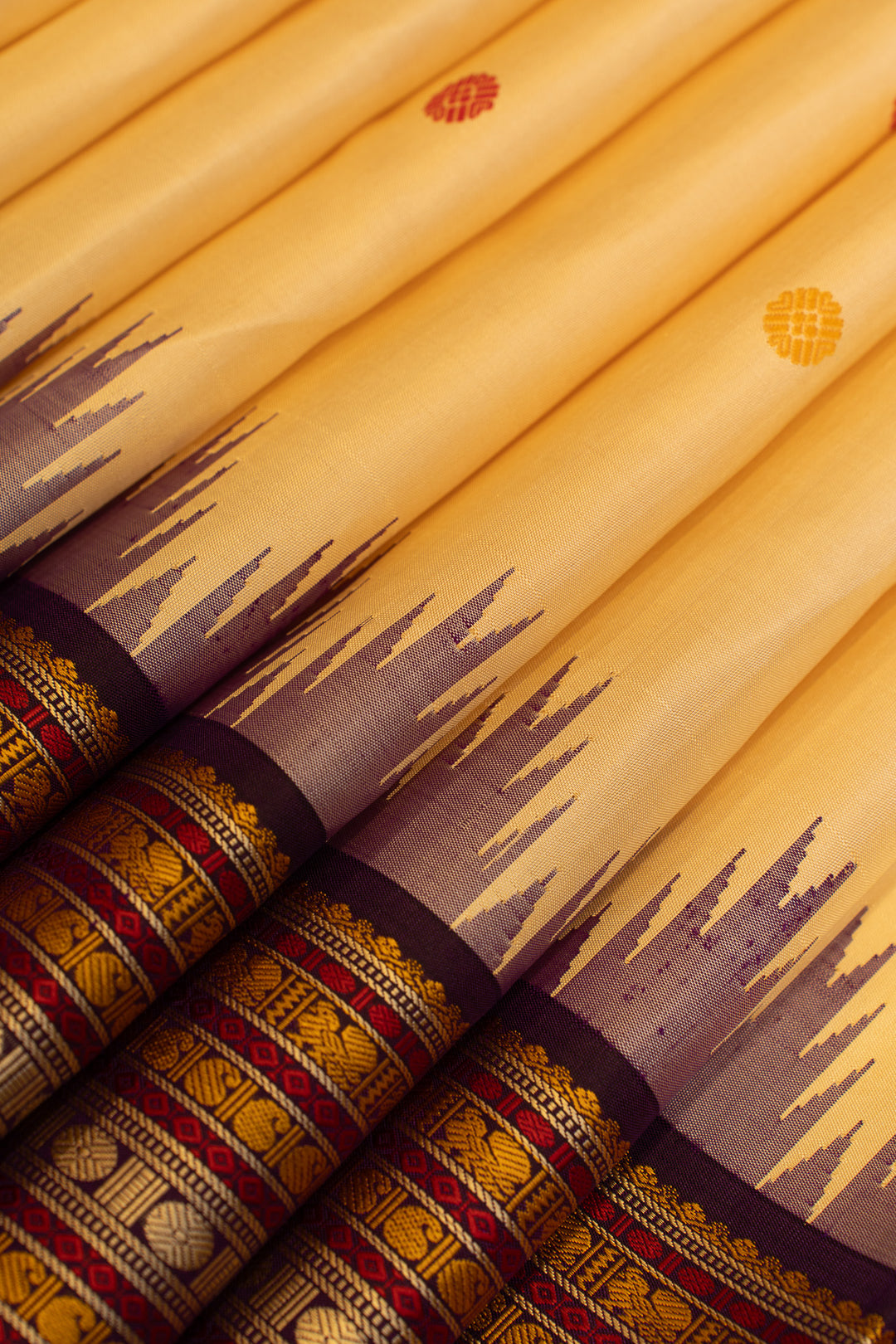 Close-up of yellow fabric with brown and red patterns