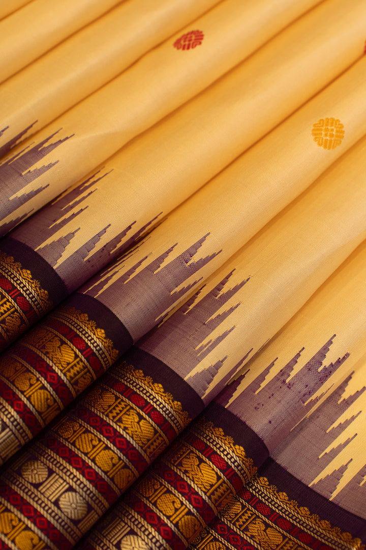 Close-up of yellow fabric with brown and red patterns
