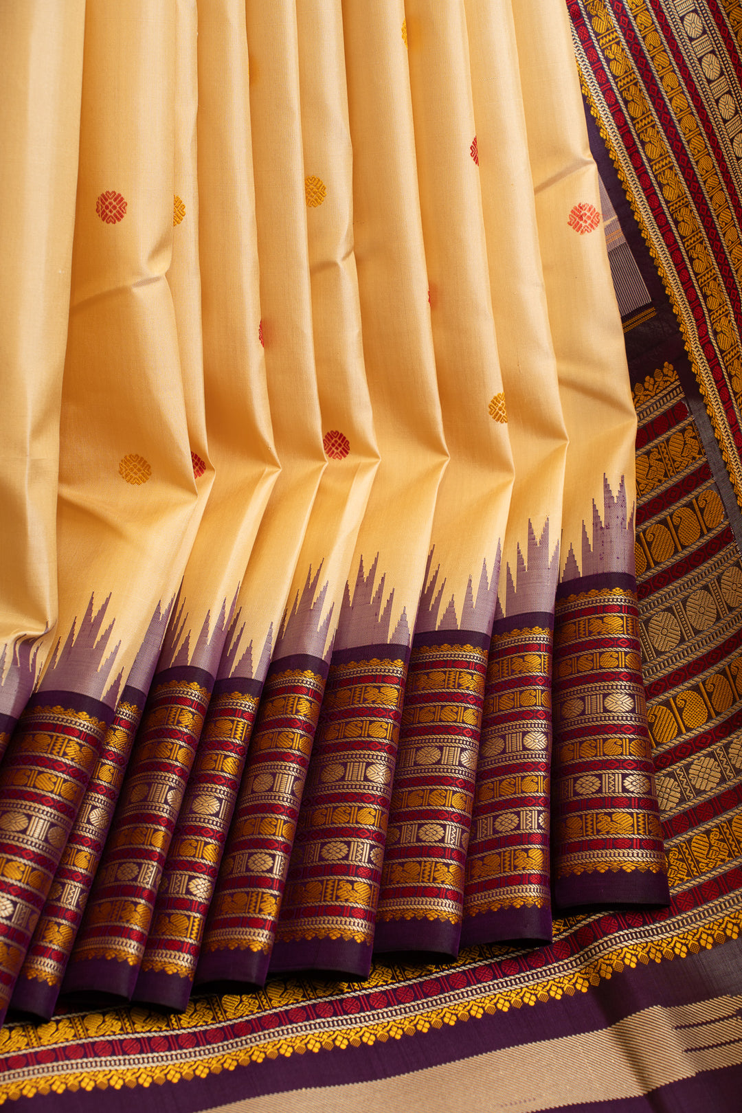 Close-up of a traditional yellow saree with purple and gold border