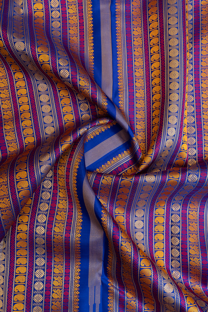 Close-up of a fabric with blue, gold, and purple stripes and patterns.