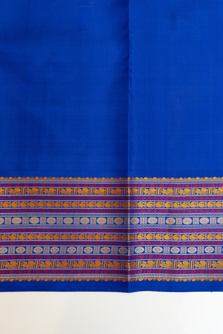 Blue fabric with a decorative border featuring elephants and patterns.