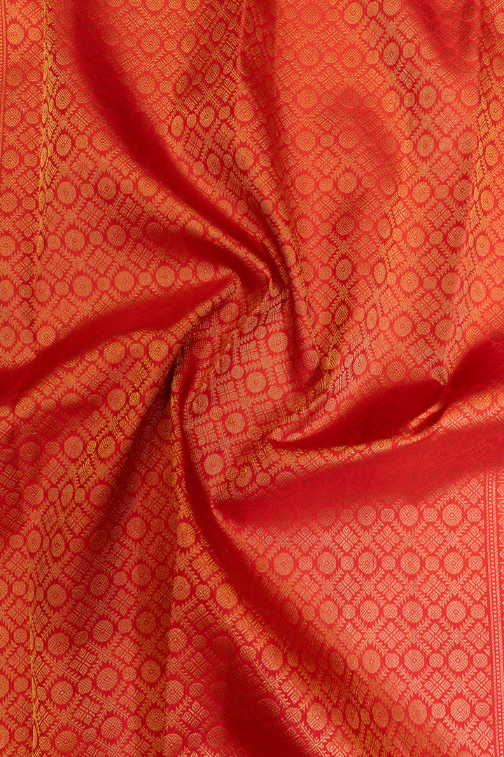 Close-up of red fabric with gold circular pattern