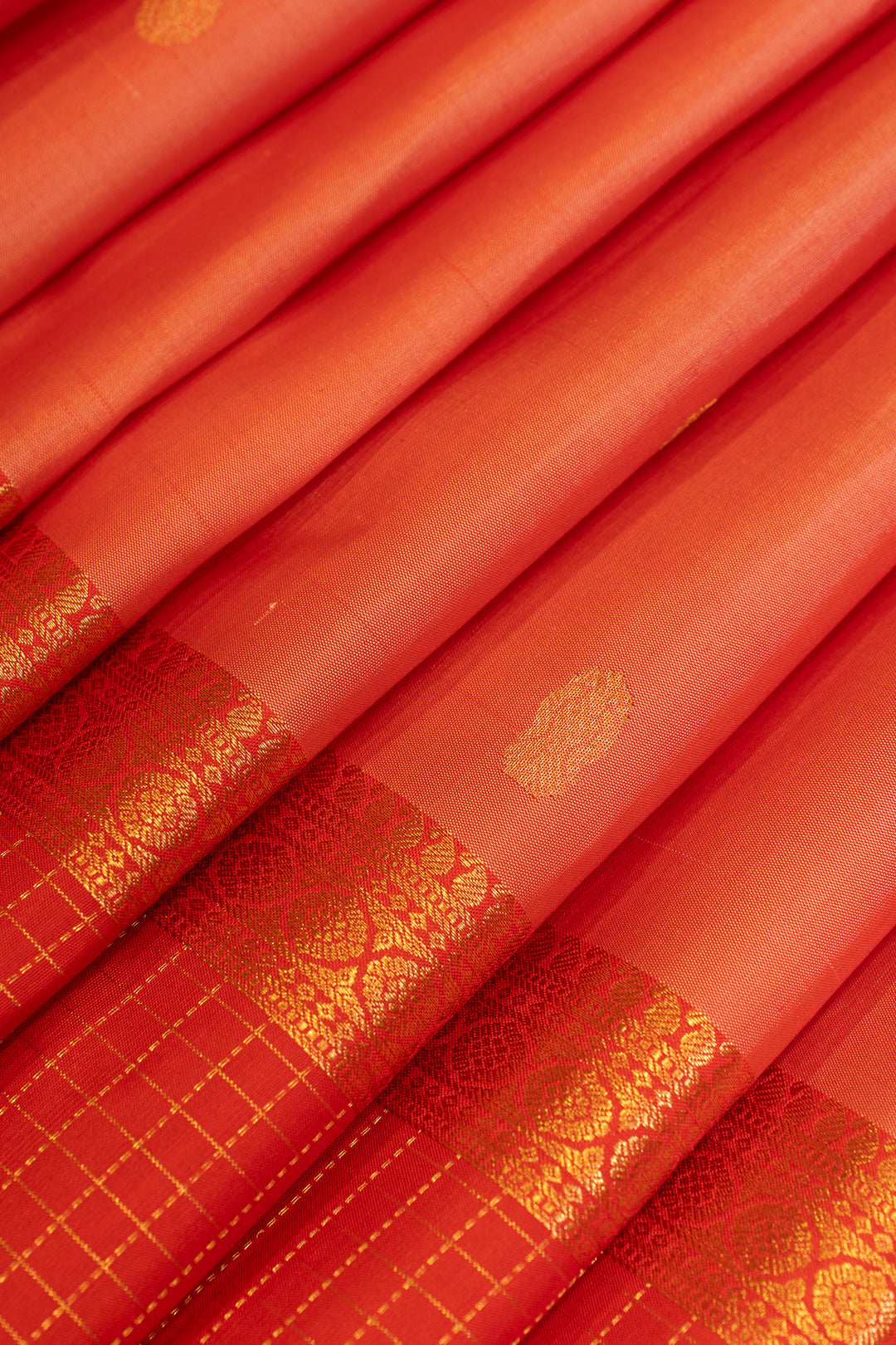 Close-up of red fabric with gold patterns