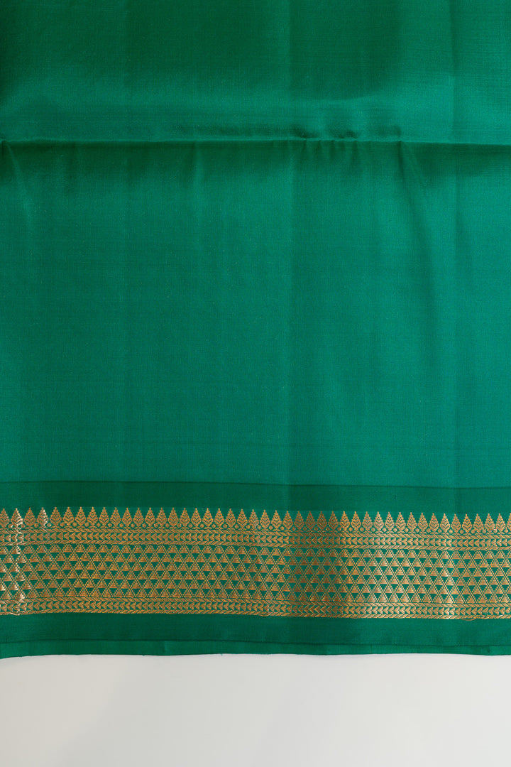 Green fabric with a gold border on a white background