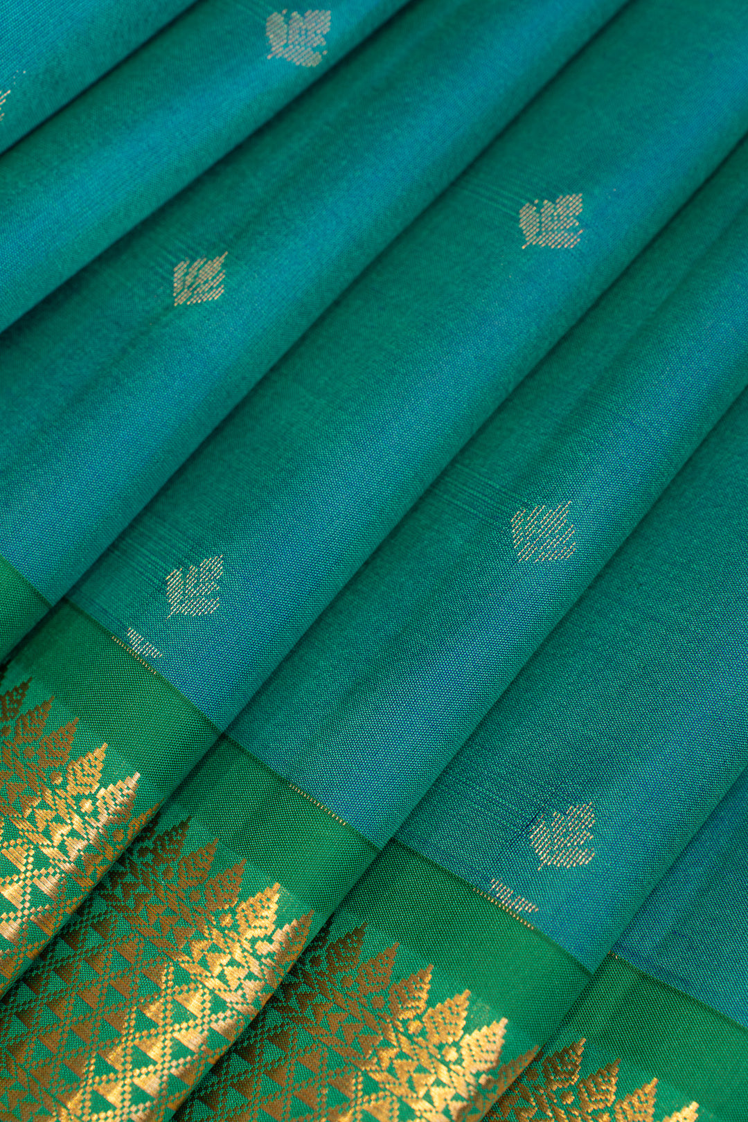 Close-up of a green fabric with gold patterns