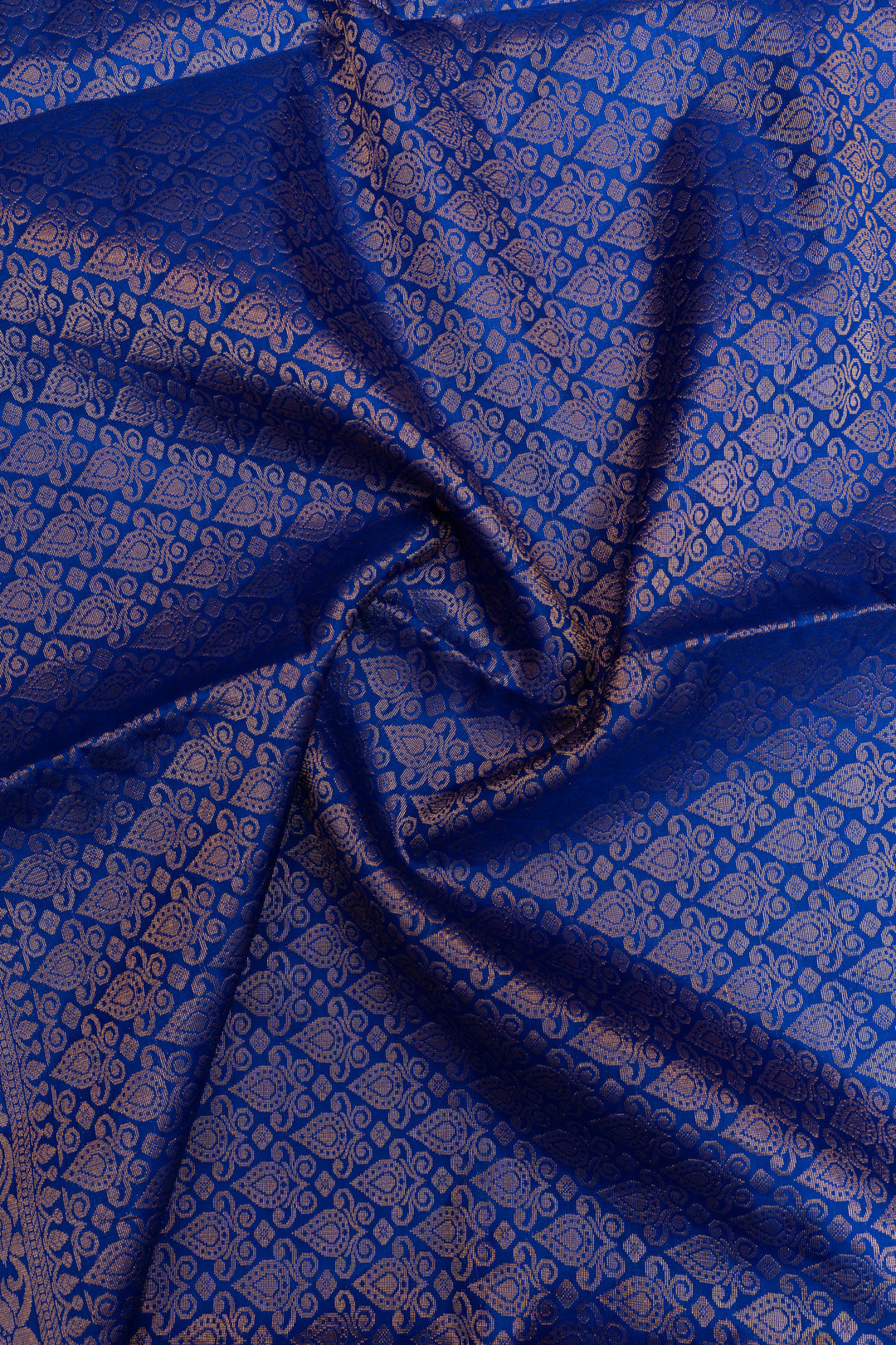 Blue fabric with intricate patterns, possibly silk or satin.
