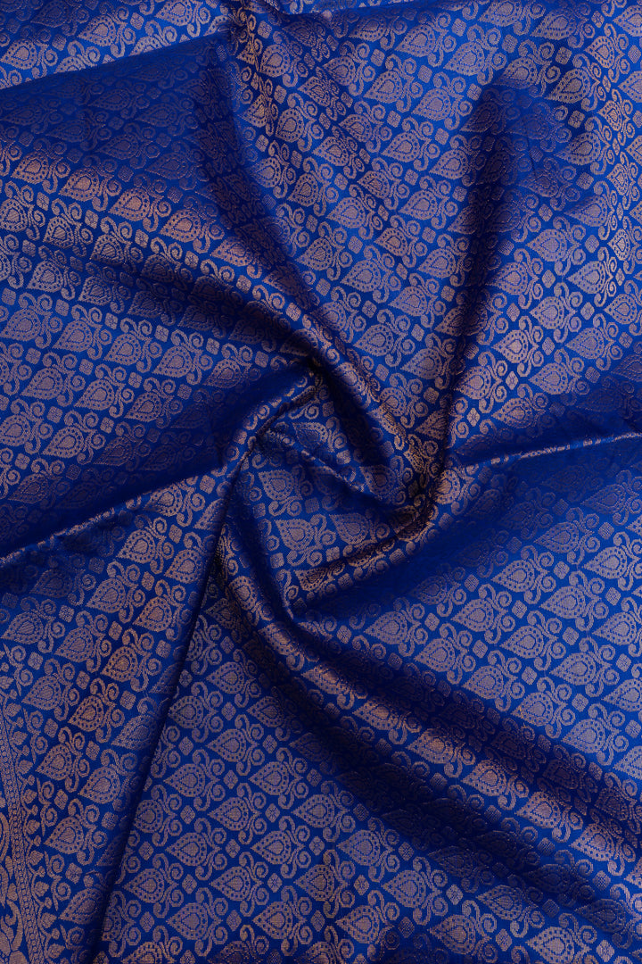 Blue fabric with intricate patterns, possibly silk or satin.
