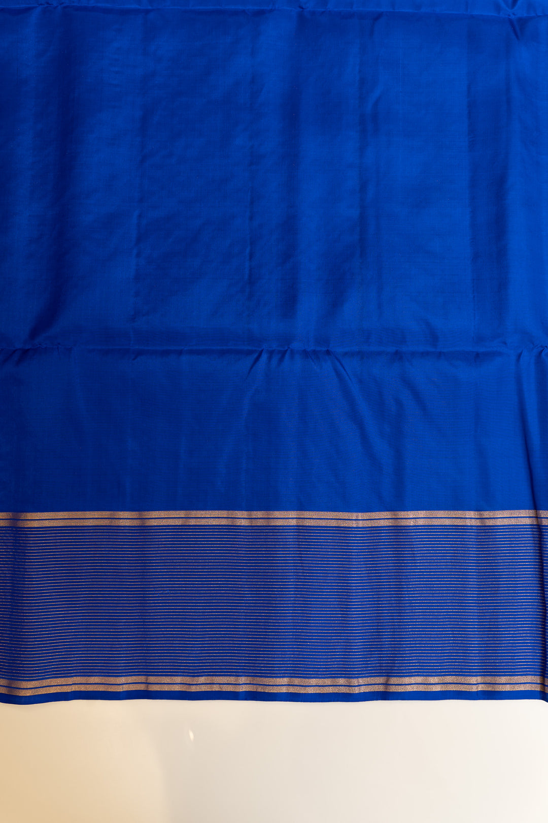 Blue fabric with a subtle pattern on a plain background